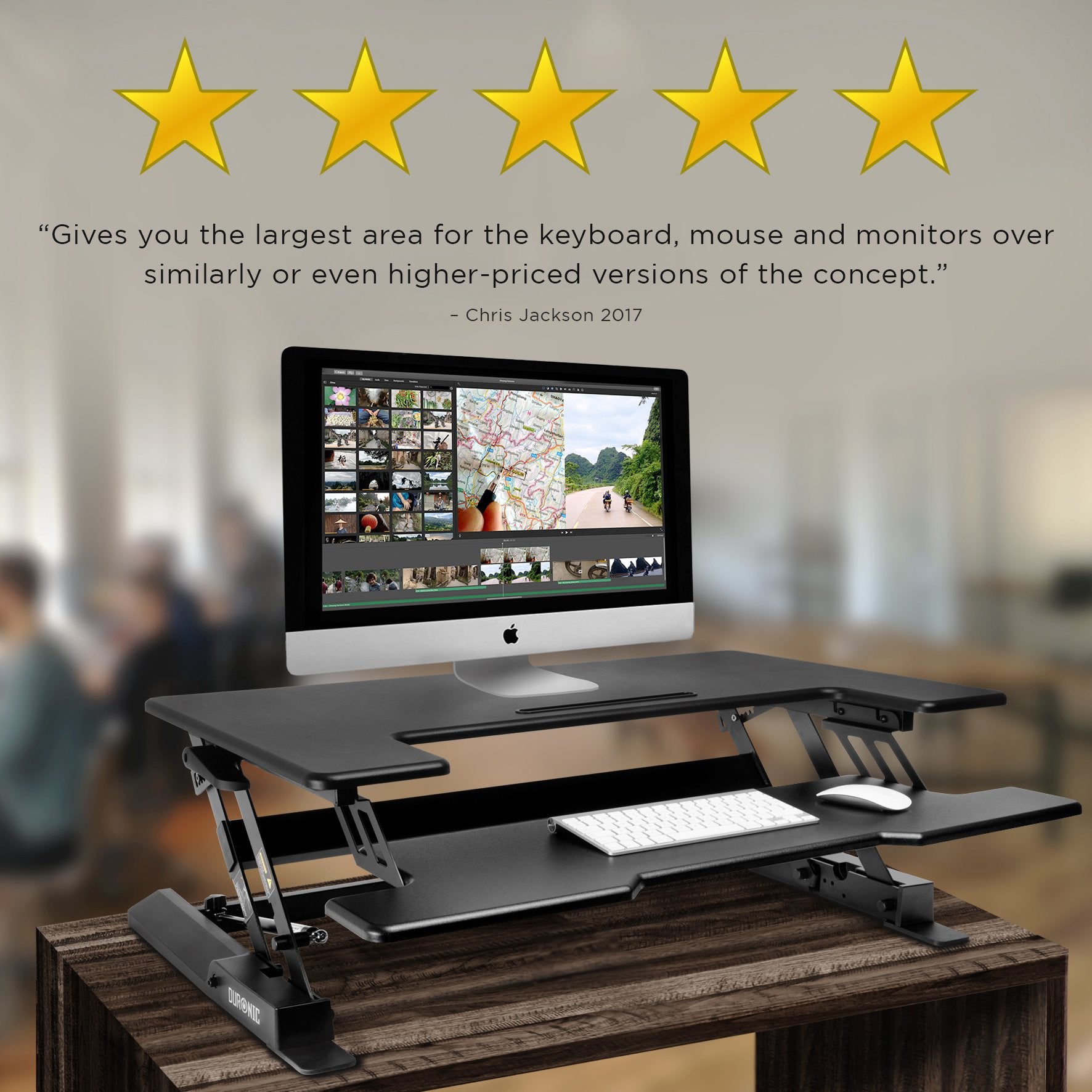 Duronic Sit-Stand Desk with dual tiers holding an Apple Mac computer, keyboard, and mouse.