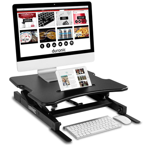 Duronic Sit-Stand Desk with monitor, tablet in slot, wireless keyboard, and mouse.