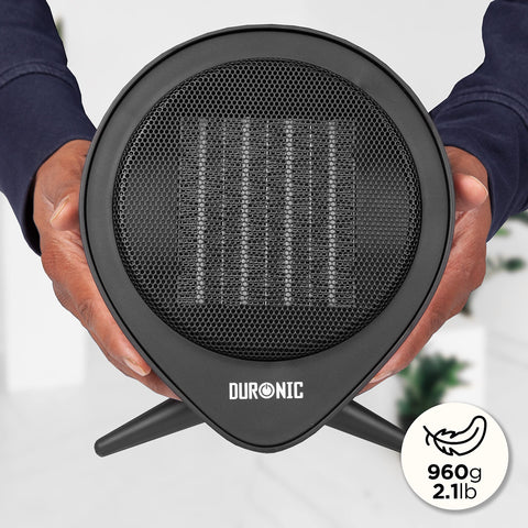Duronic Small Ceramic Fan Heater lightweight black circular design held in two hands for scale.