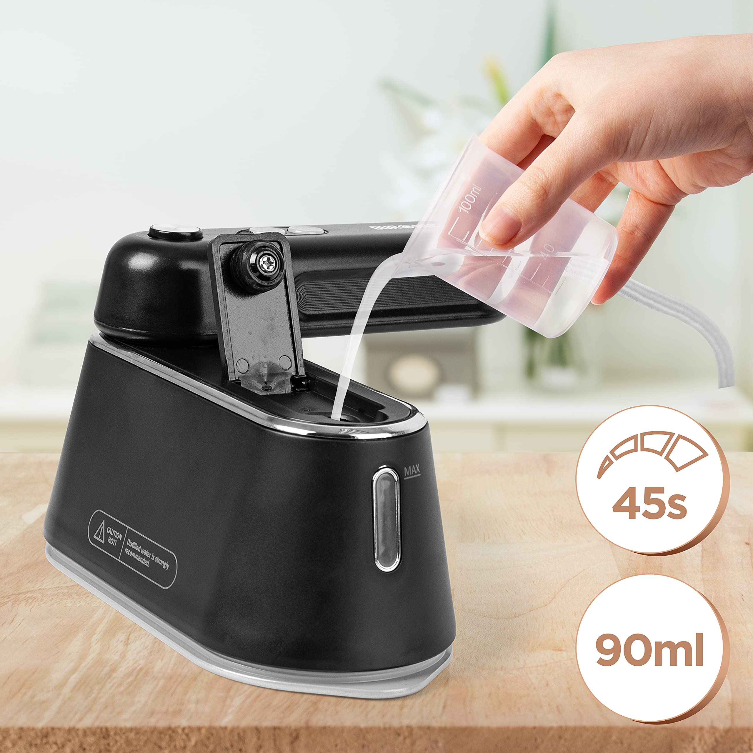 Duronic Steam Irons with water from a measuring cup on a wooden table.