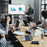 Duronic TV Mount Stand Bracket with A man presenting charts on a monitor to colleagues
