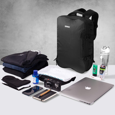 Duronic Travel Cabin Bags surrounded by neatly arranged clothing, a laptop, camera, and toiletries.