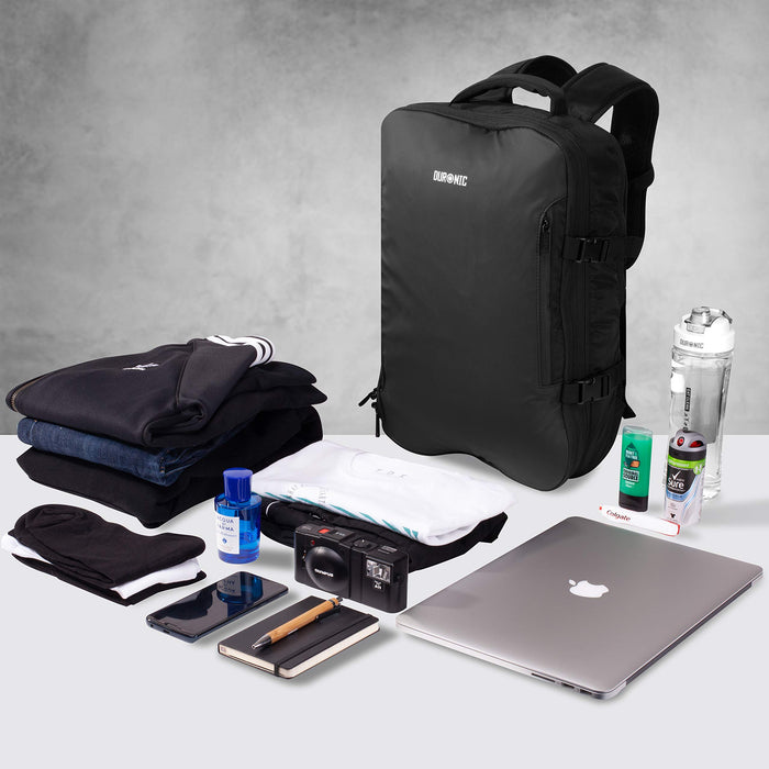 Duronic Travel Cabin Bags surrounded by neatly arranged clothing, a laptop, camera, and toiletries.