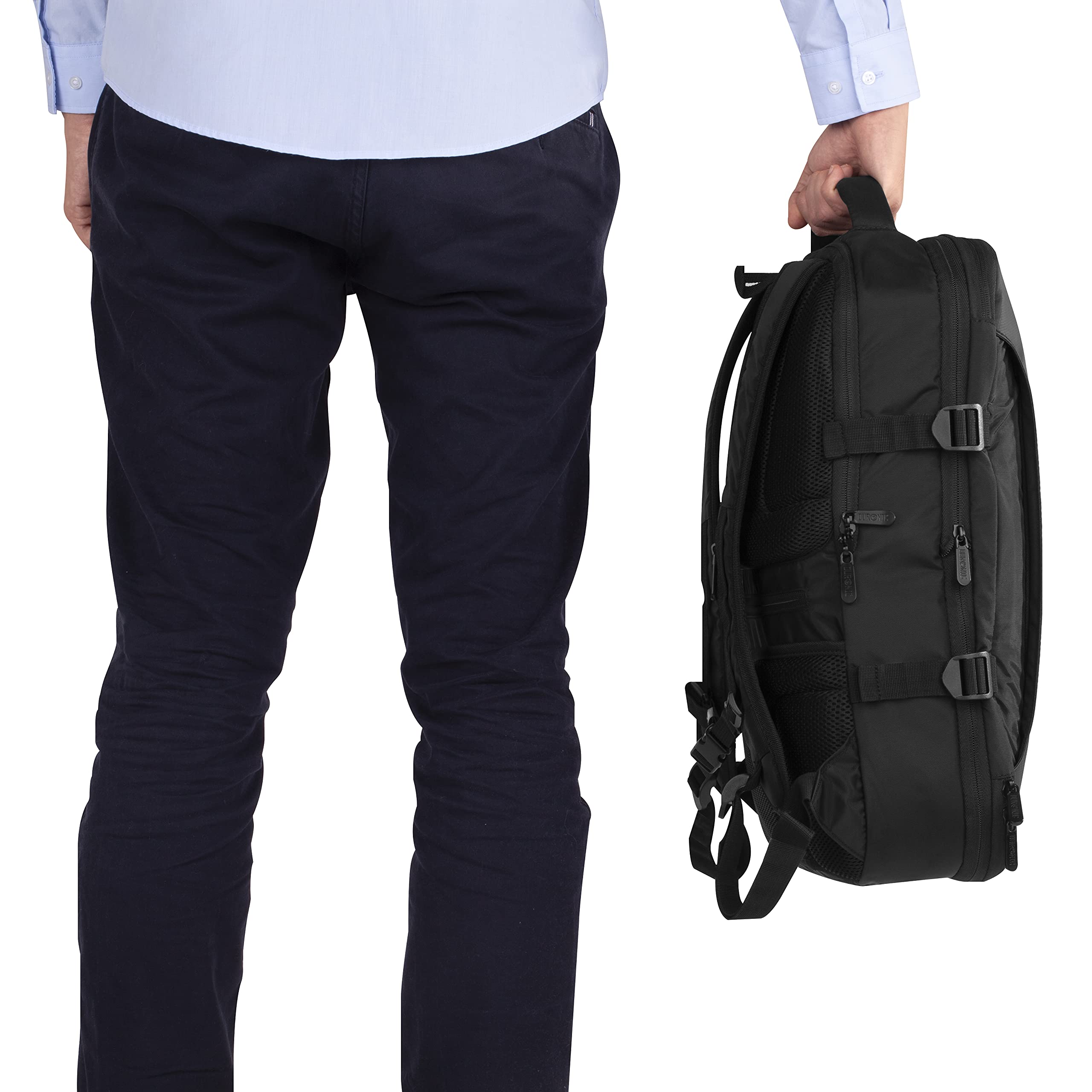 Duronic Travel Cabin Bags with Man holding a black commuter backpack by its top handle next to his leg.