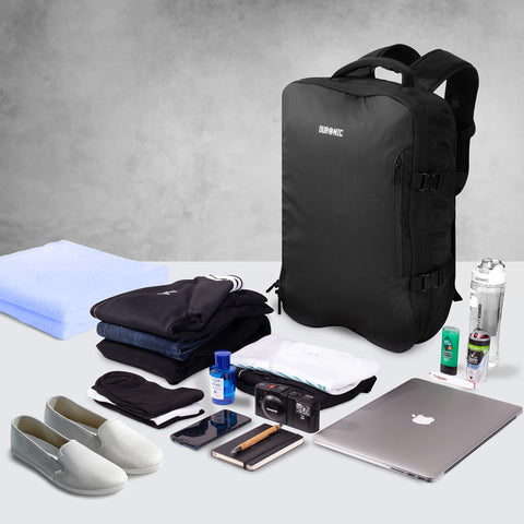 Duronic Travel Laptop Backpack surrounded by packed travel items, clothes, shoes, laptop, and toiletries for Shopify.