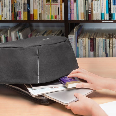 Duronic Travel Laptop Backpack with a silver laptop, magazines, and a small box.