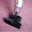 Duronic VC7 Vacuum Cleaner Accessories with red power icon on textured purple carpet, clear dust bin.