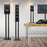 Three different sizes of black speaker stands supporting audio monitors in a music studio setting.